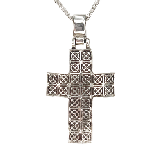 Silver cross pendant on a white background