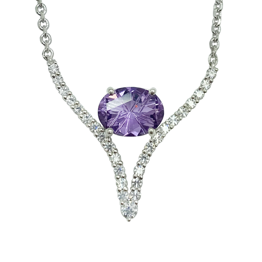 Silver necklace with an oval amethyst in the center and a V-shaped line of clear stones on either side.