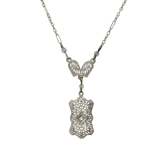 Silver necklace featuring a delicate filigree design with a central diamond.