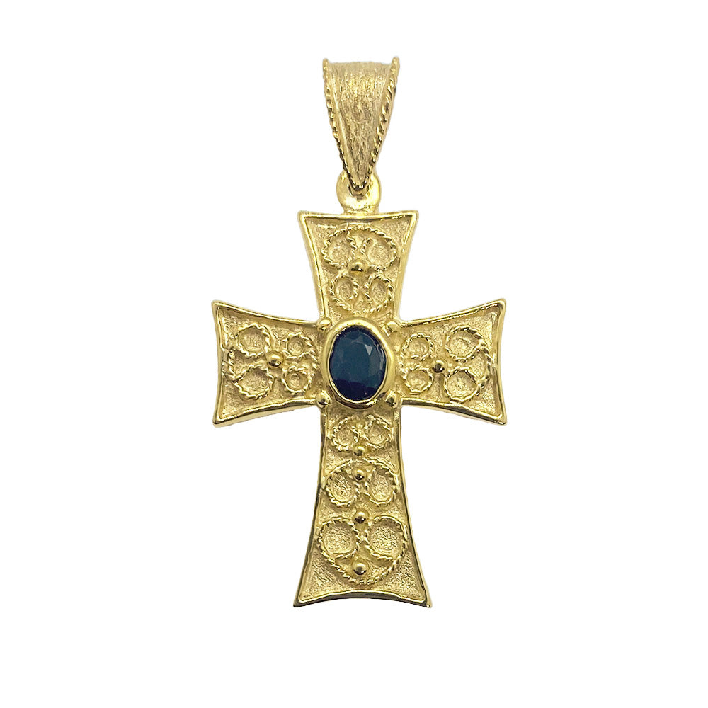 Gold cross pendant with a center gemstone on a white background