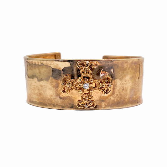 Gold-toned cuff bracelet with a hammered finish, featuring a central Byzantine cross embellished with a diamond and intricate filigree details.