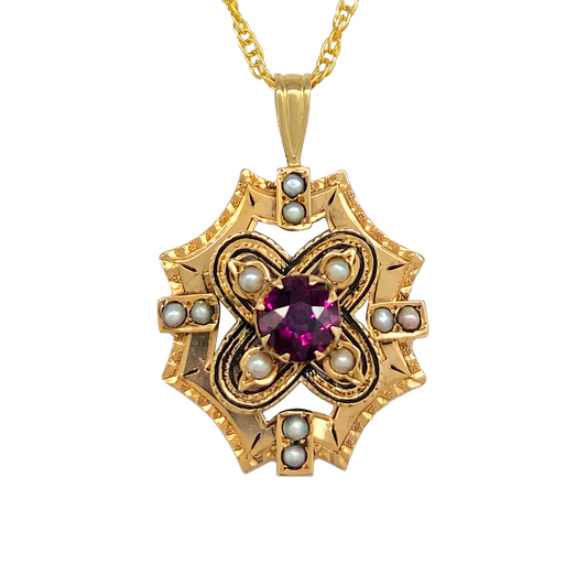 Gold pendant featuring a central garnet surrounded by a geometric design of pearls.