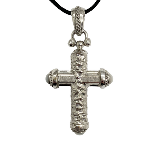 Silver cross pendant on a white background