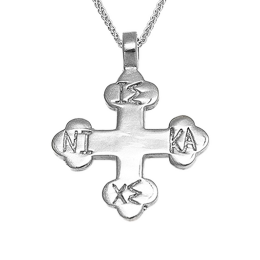 Silver cross pendant on a white background