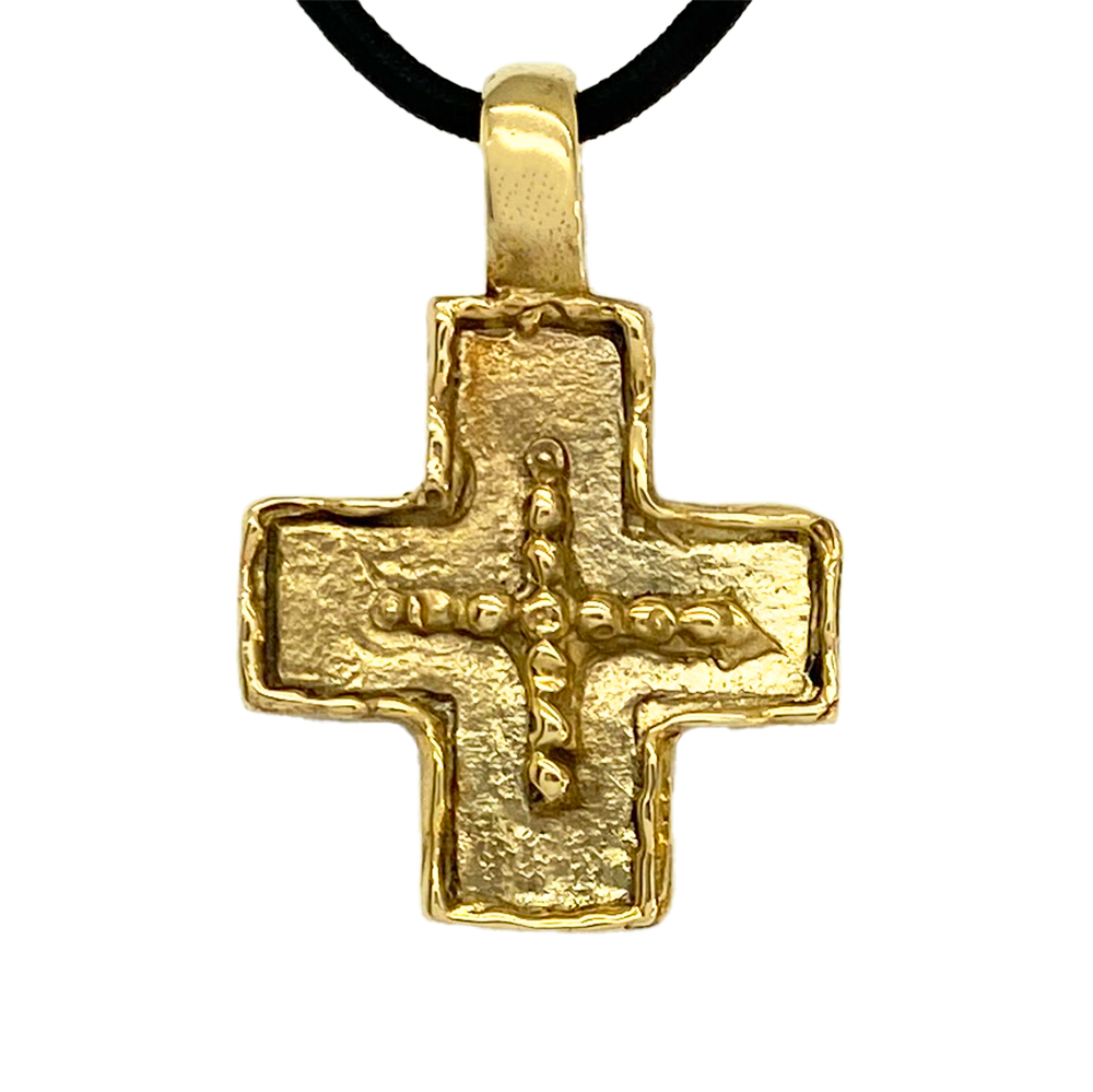 Gold cross pendant on a white background