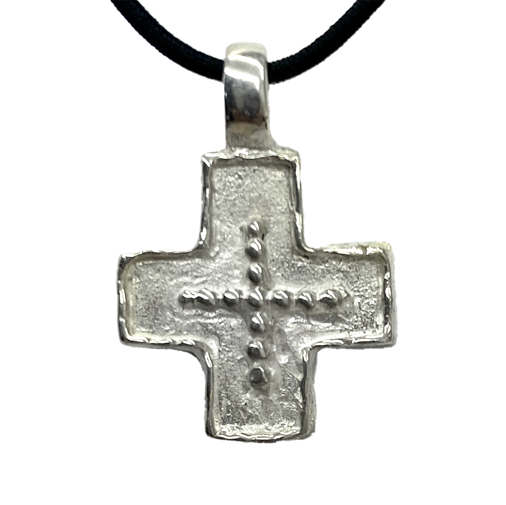 Silver cross pendant on a white background