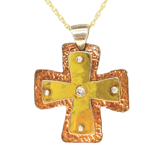 Gold cross pendant with gemstone.