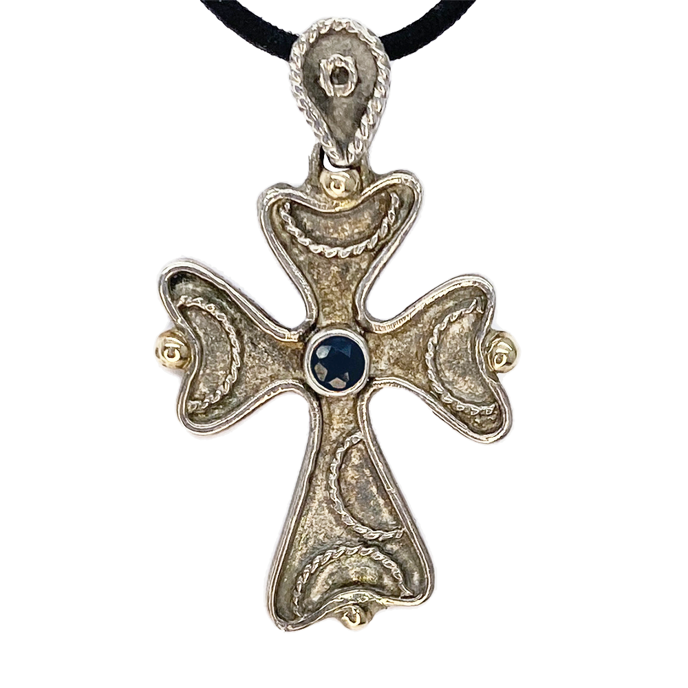 Silver cross pendant with gemstone.