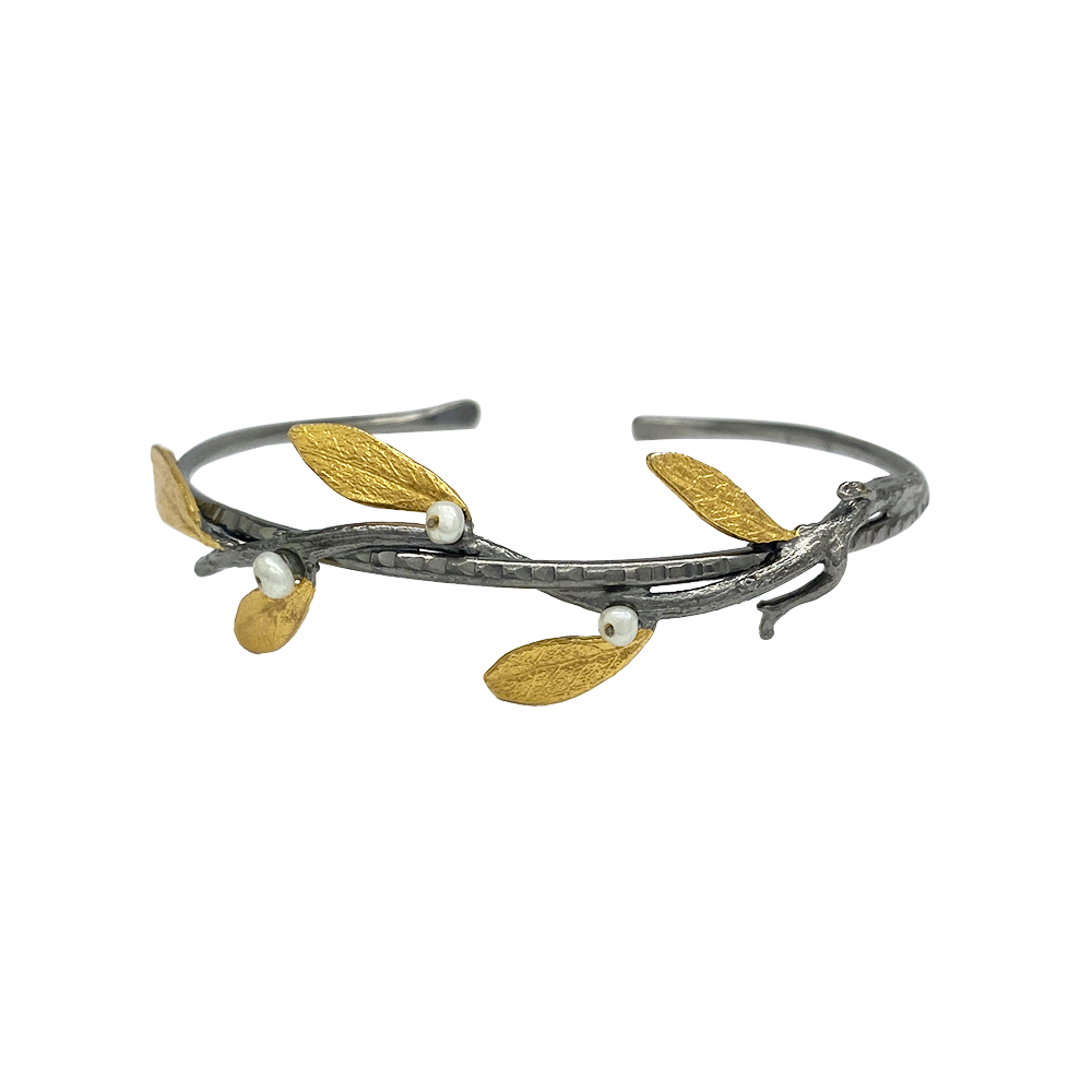 Silver ring with an oxidized band and gold-plated olive leaf design.