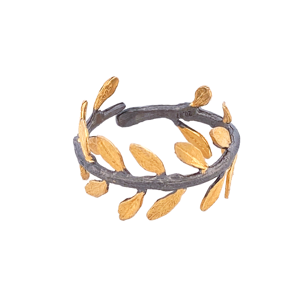 Silver ring with an oxidized band and gold-plated olive leaf design.