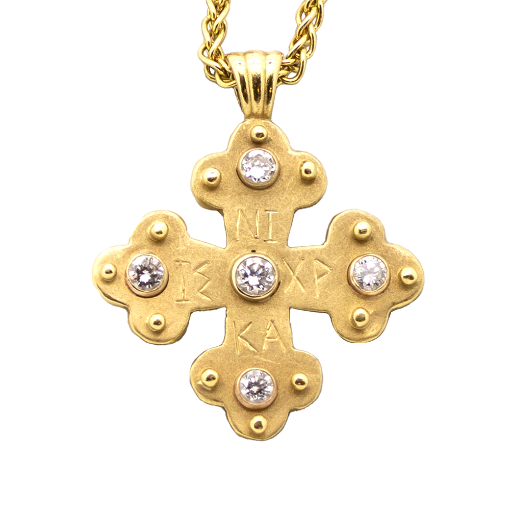 Gold cross pendant with gemstone.