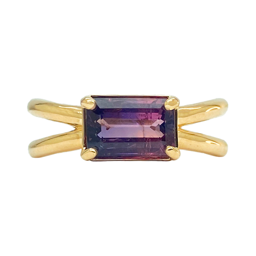 Emerald-cut amethyst ring with a gold split shank band.