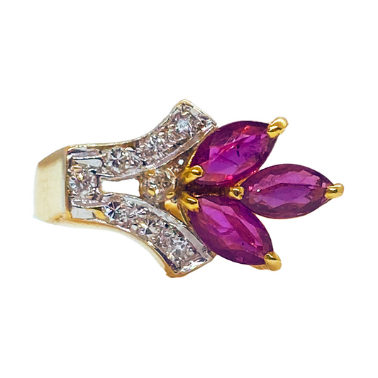 Gold ring featuring three marquise-cut rubies in a flower-like cluster, accented with smaller round diamonds.