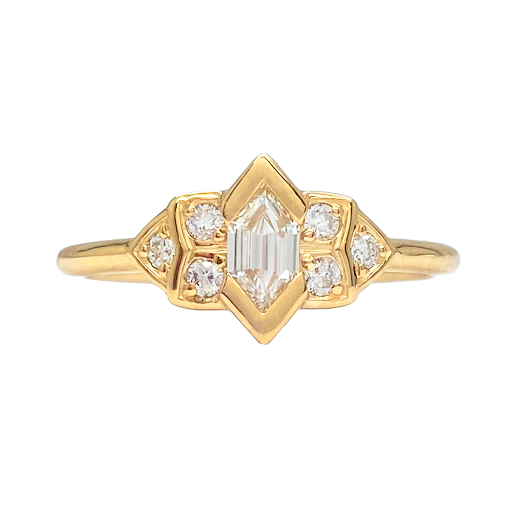 Gold ring with a radiant-cut center diamond and smaller diamond accents in a starburst setting.