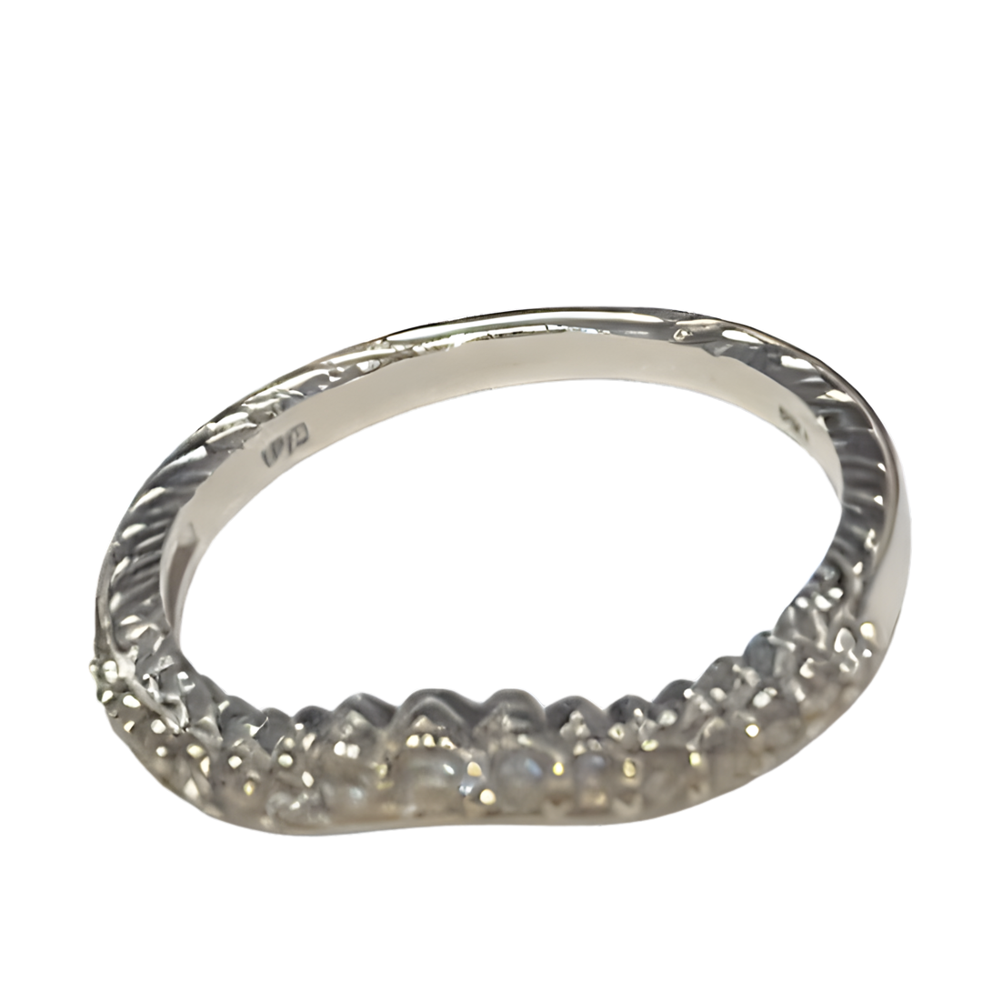 Silver wedding band with a curved design and diamond accents, on a white background