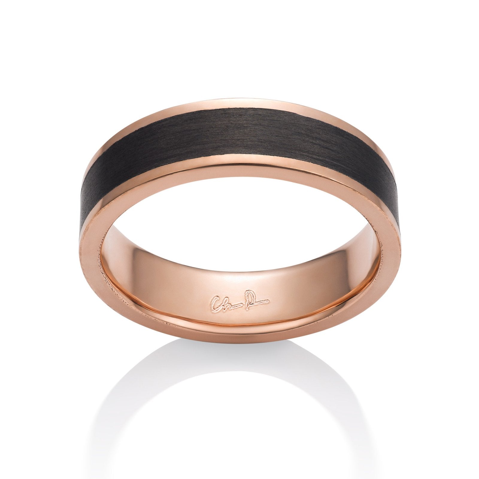 Rose gold ring with a black carbon fiber inlay on a white background.