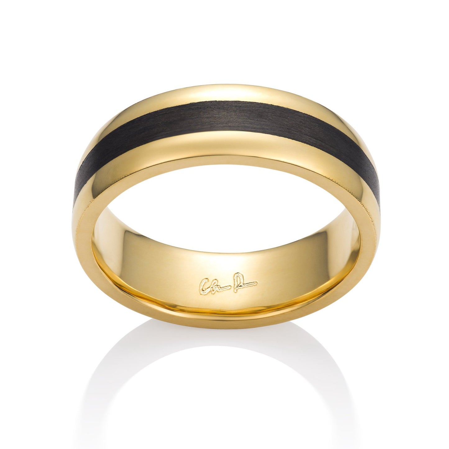 Yellow gold ring with a black carbon fiber inlay on a white background.