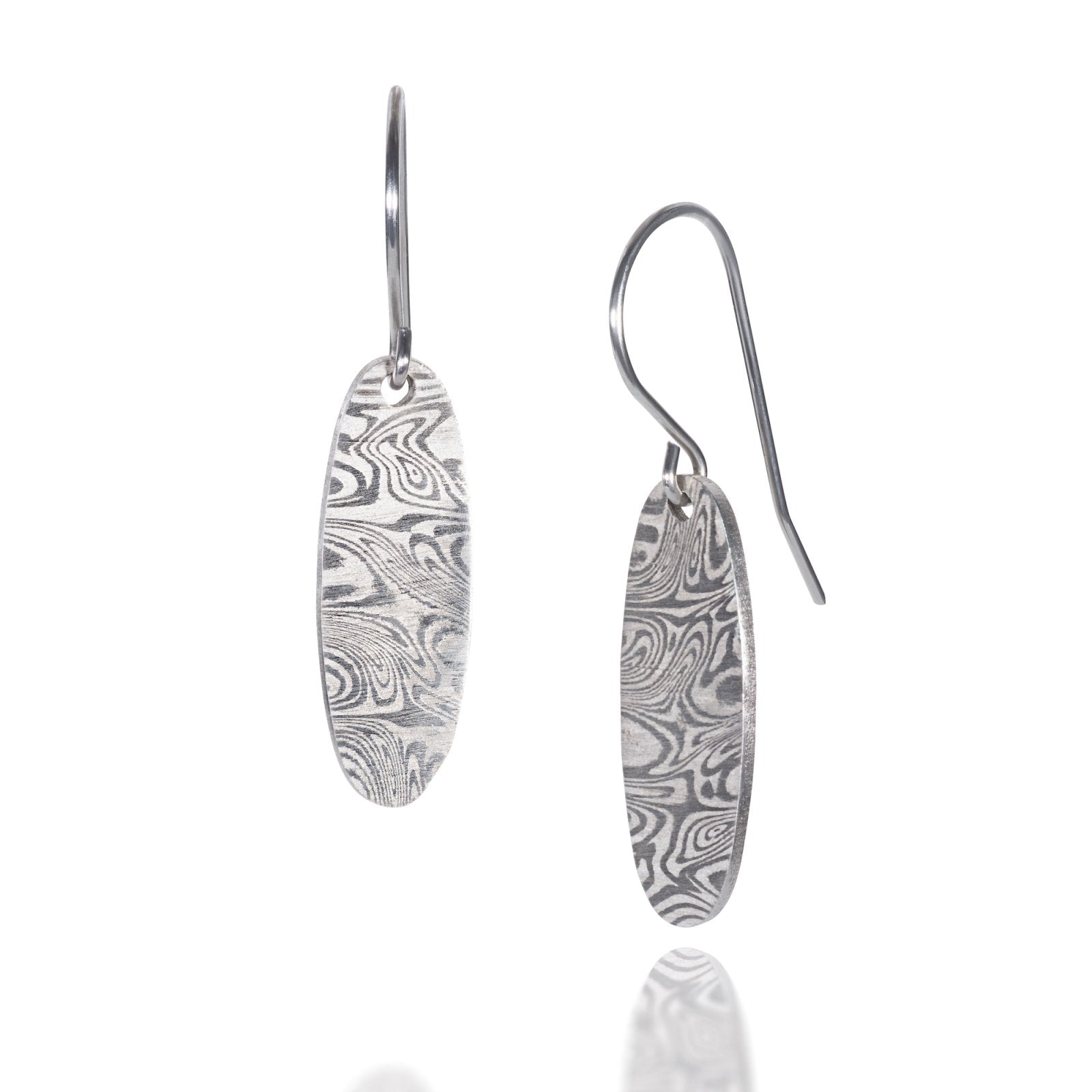 Pair of silver oval earrings with a textured, swirling pattern, on a white background.