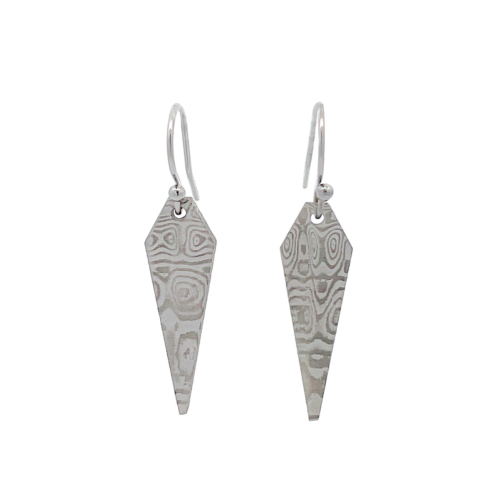 Pair of silver earrings with a danascus steel pattern, on a white background.