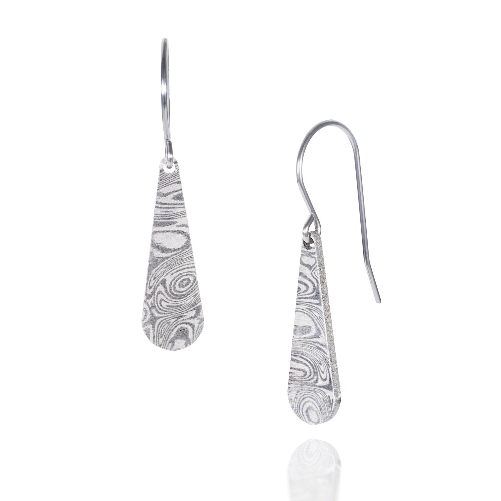 Pair of silver earrings with a danascus steel pattern, on a white background.