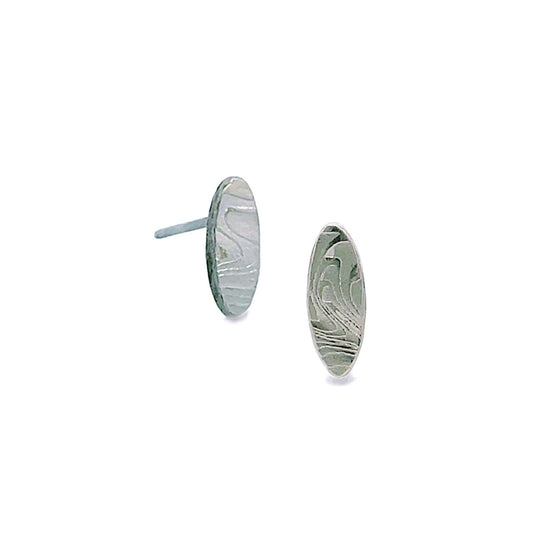 Pair of silver oval shaped earrings with a damascus steel pattern, on a white background.