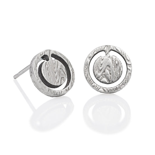 Pair of silver round shaped earrings with a damascus steel pattern, on a white background.