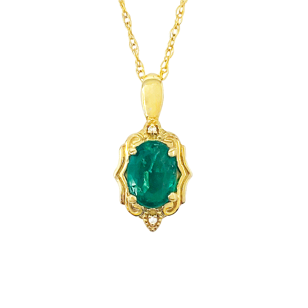 Gold necklace with an emerald pendant on a white background.