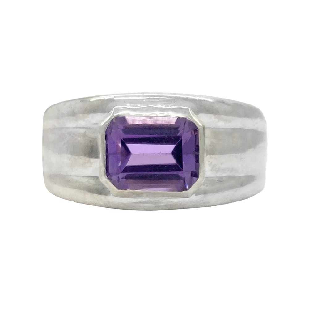 Silver ring with a rectangular amethyst in the center.