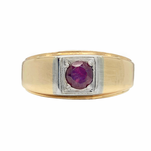 Two-tone men's ring with a red oval gemstone in the center. The ring has a wide band with a flat top and a grooved edge. 