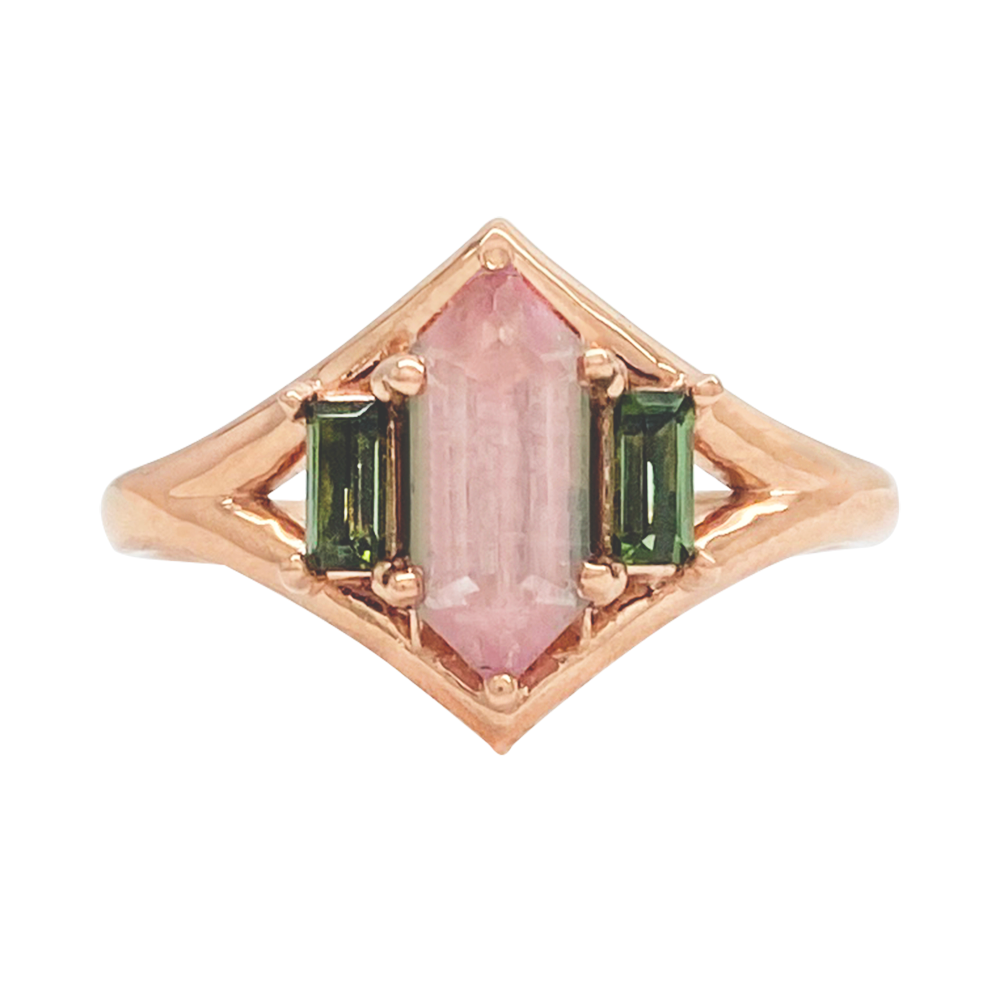 Rose gold ring with a rectangular watermelon tourmaline center stone flanked by two rectangular green tourmaline stones.