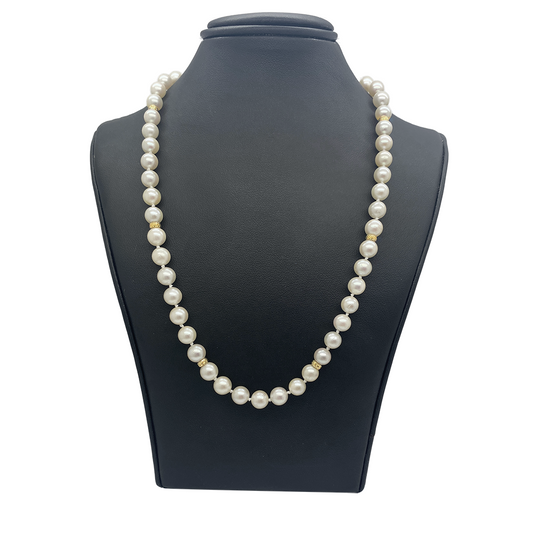 White pearl necklace worn on statue