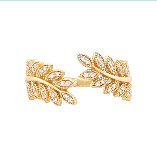 Gold band ring with two intertwining leaf-shaped branches adorned with sparkling diamonds.