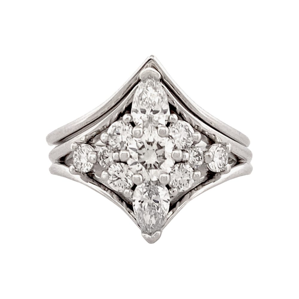 Silver diamond cocktail ring featuring a cluster of round and marquise-shaped diamonds, set in a starburst pattern.