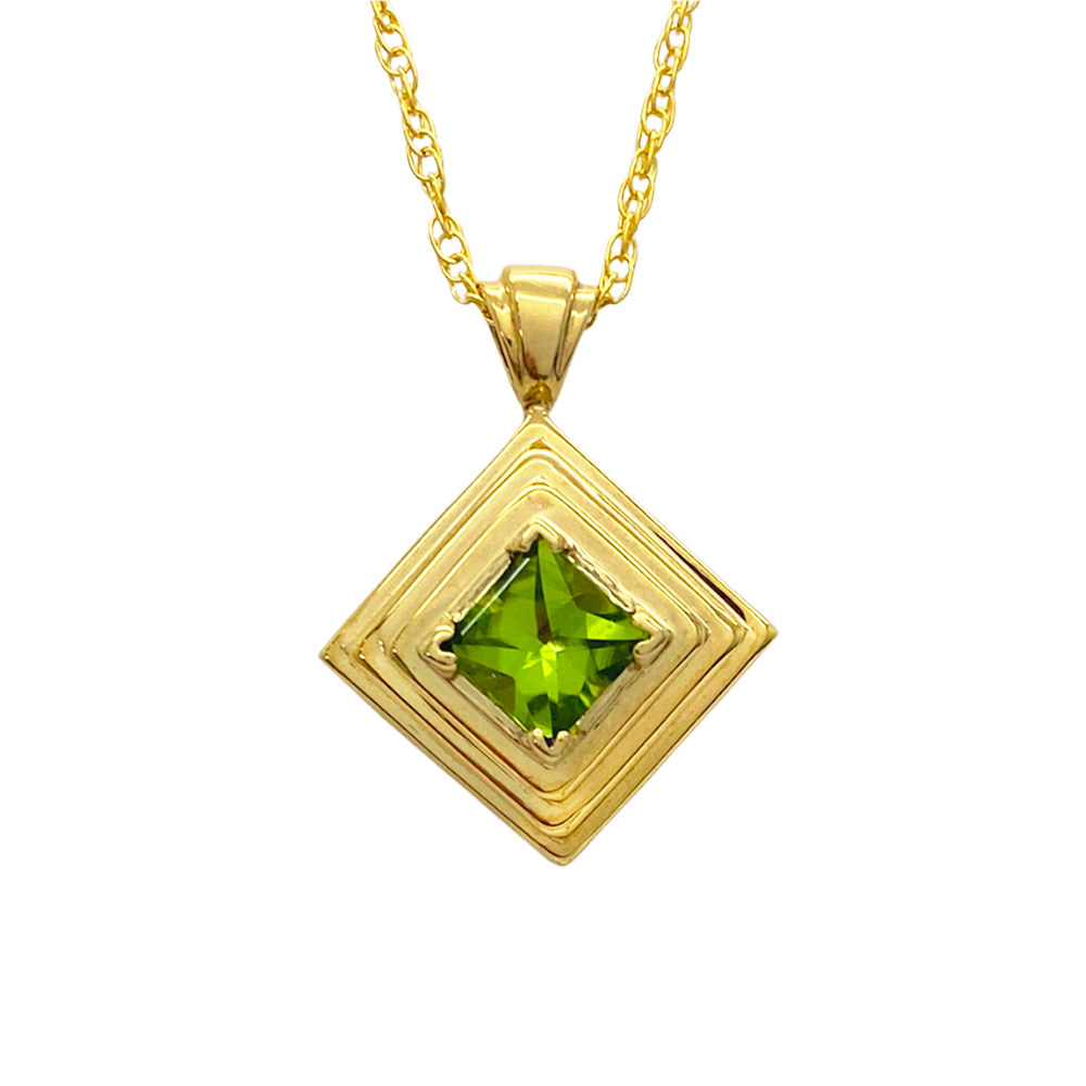 Gold pendant with a square peridot stone in a layered, geometric setting.