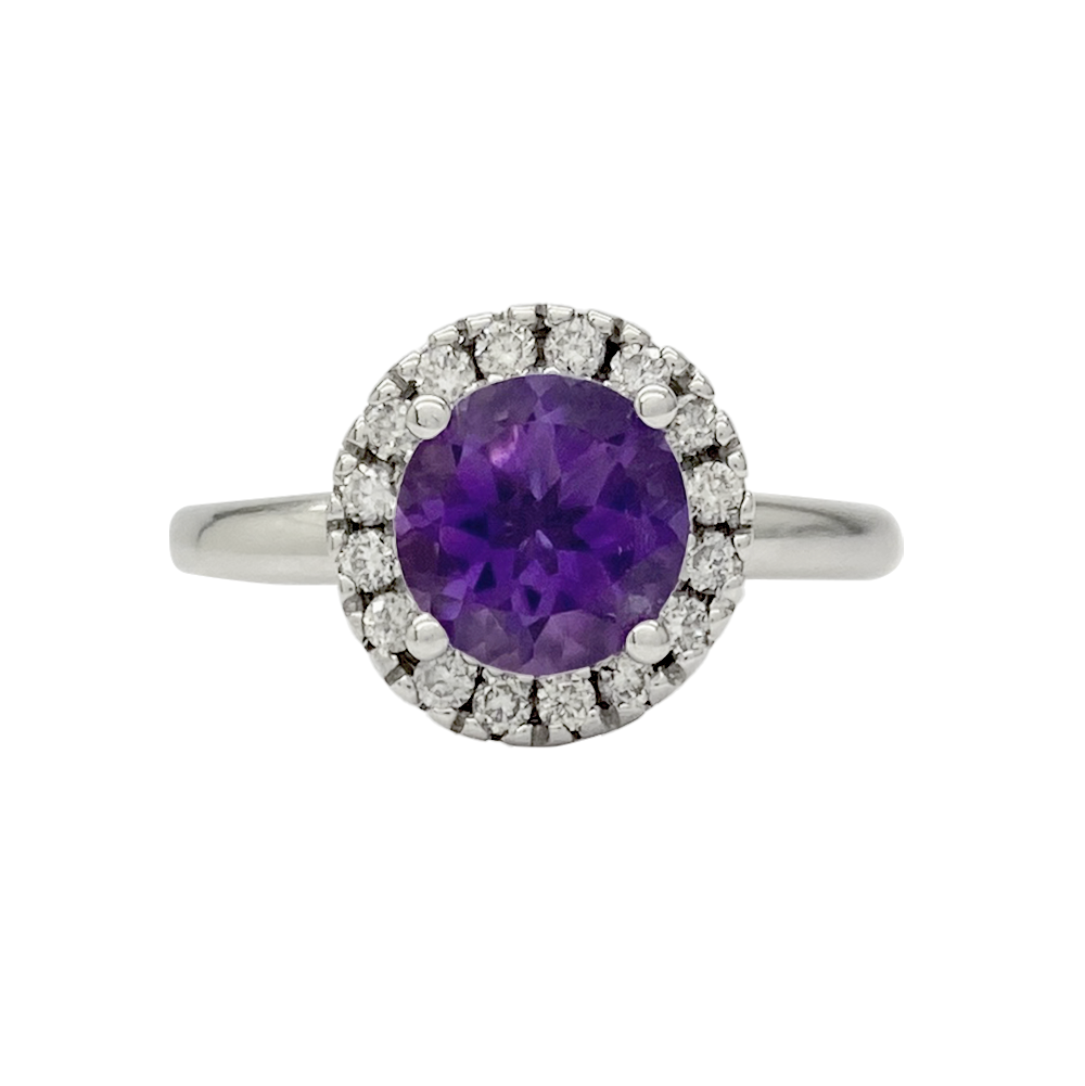 Silver ring with an oval amethyst center stone surrounded by a halo of round diamonds