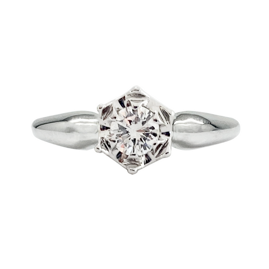 Silver engagement ring with a hexagonal setting and a round center stone.