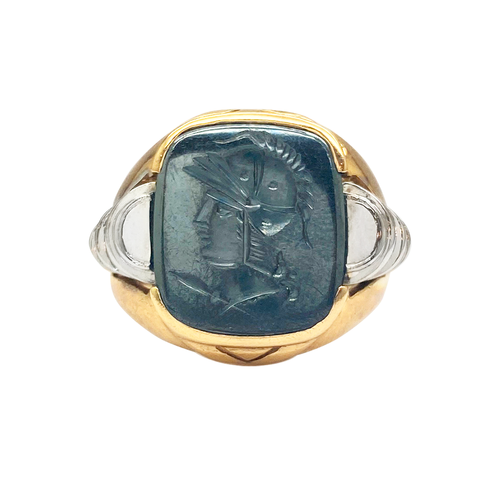 Gold ring with a carved hematite stone, features a profile of a warrior wearing a helmet.