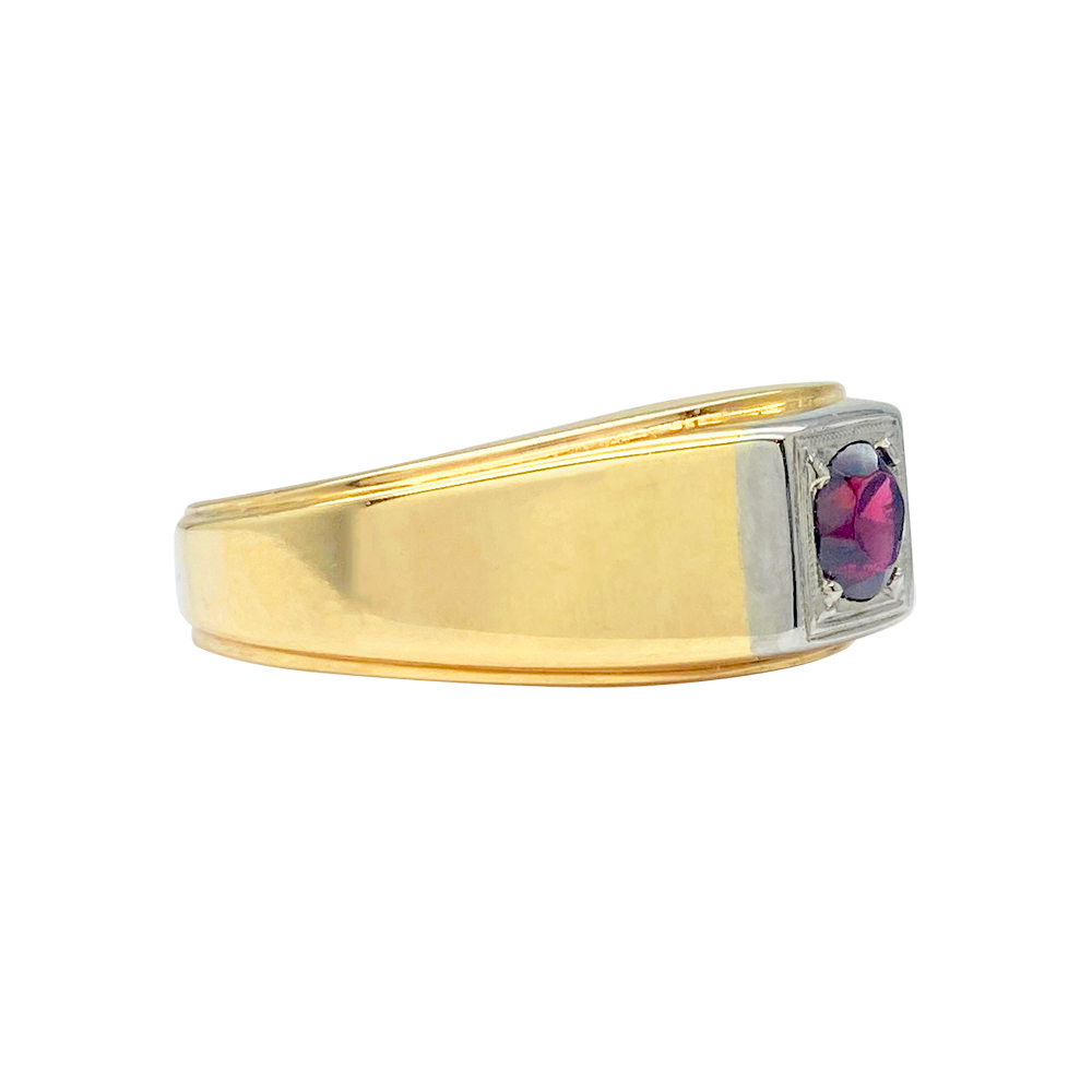 Gold ring with a square-cut rhodolite garnet in a bezel setting. The ring has a two-tone gold band with a flat profile.