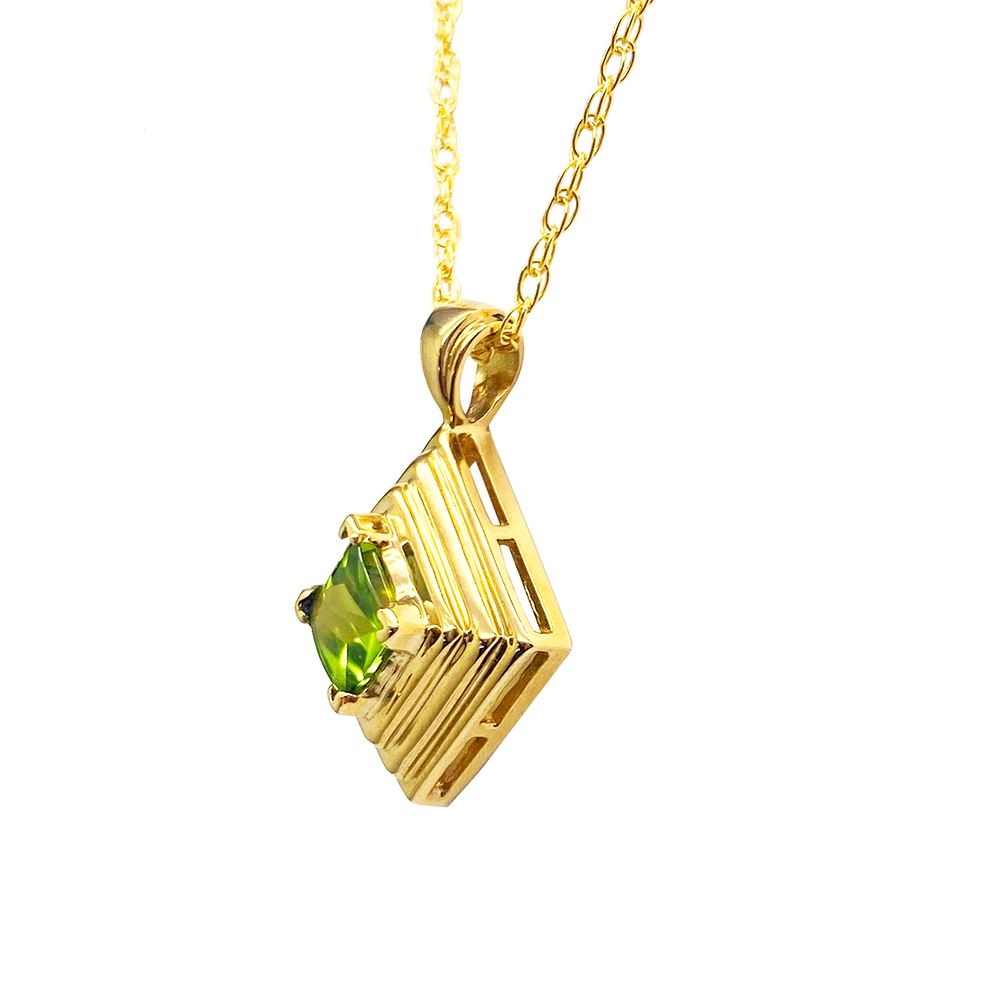 Gold pendant with a square peridot stone in a layered, geometric setting.