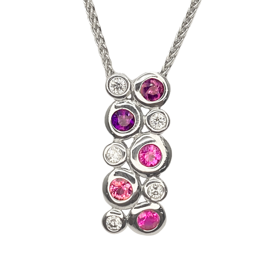  Silver necklace with a pendant featuring a cluster of mixed gemstones, including rubies, sapphires, and diamonds, on a white background