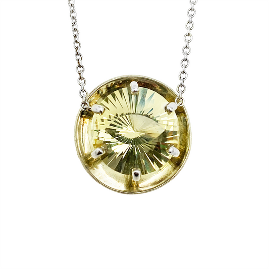 Silver necklace with a round yellow citrine pendant, on a white background