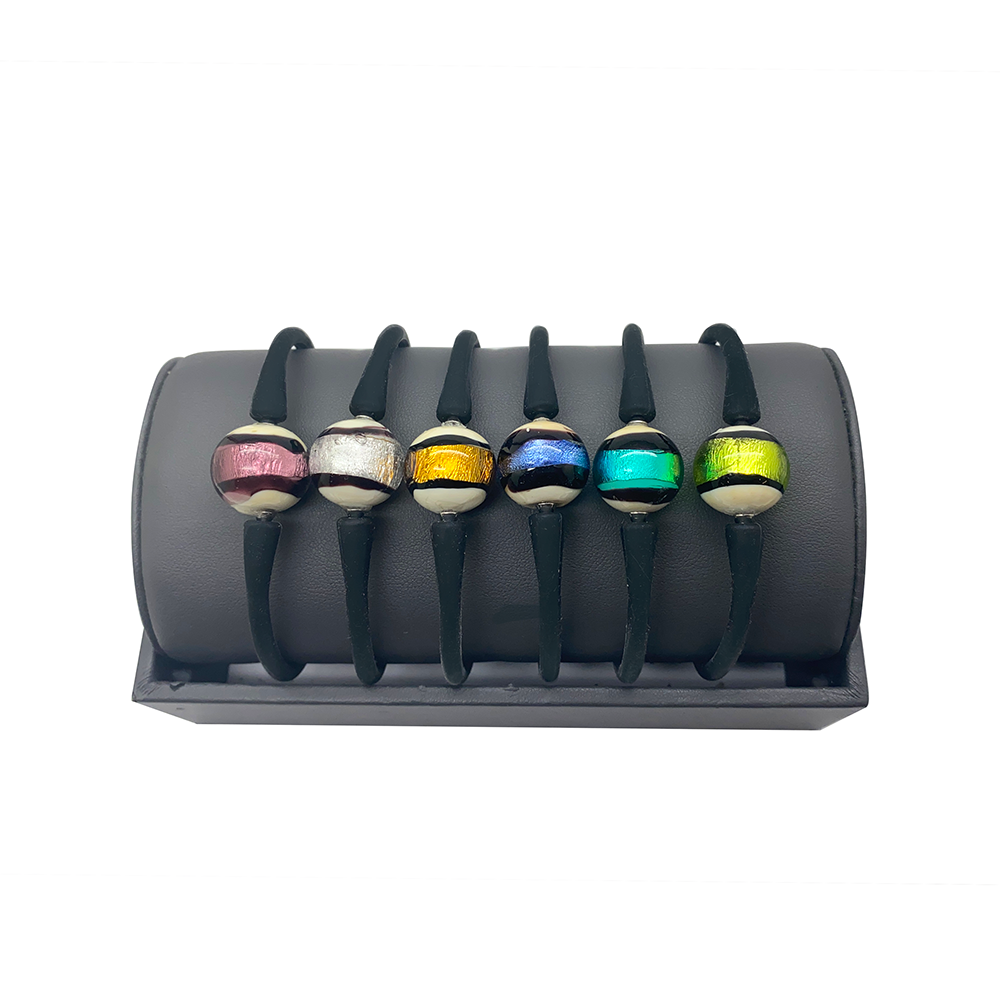 Seven bracelets on a gray display stand. Each bracelet has a black elastic band with a colorful glass bead in the center.