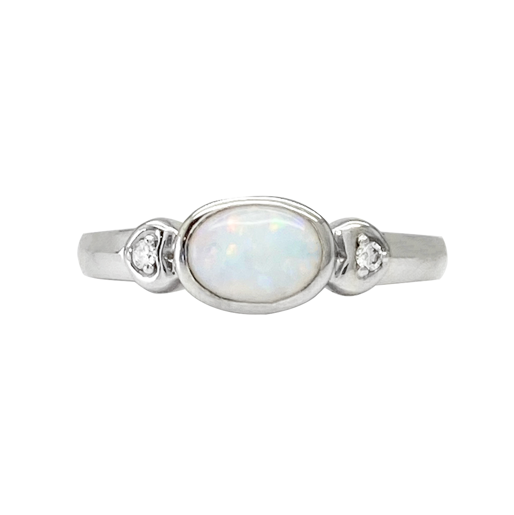 Oval opal silver ring with two heart-shaped diamond accents