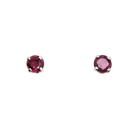 Pair of silver stud earrings with round ruby gemstones.