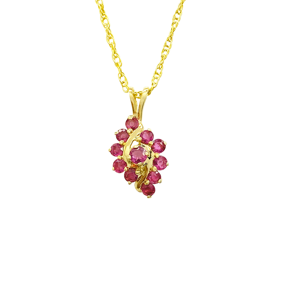 Yellow gold necklace with a cluster of oval-shaped ruby gemstones on a white background.