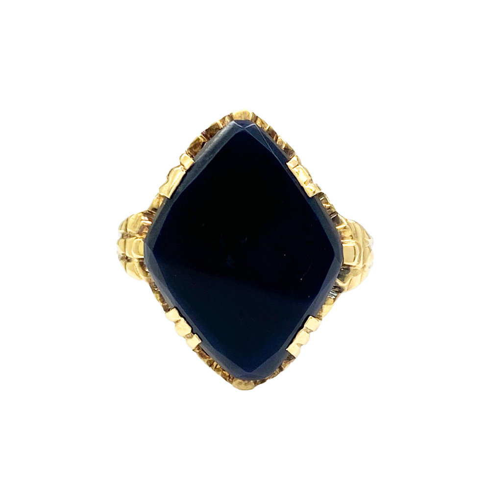 Yellow gold ring with a square black onyx center stone and textured band, on a white background.