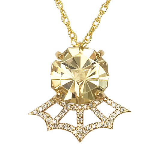 Gold necklace with a large, faceted citrine pendant. The pendant is surrounded by a delicate diamond-studded web design.