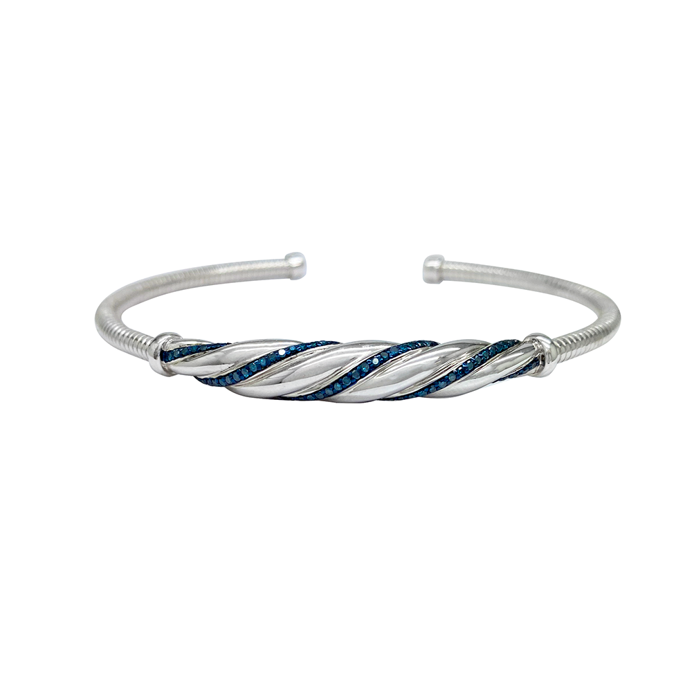 Silver bangle bracelet with a twisted design and blue gemstones on a white background.