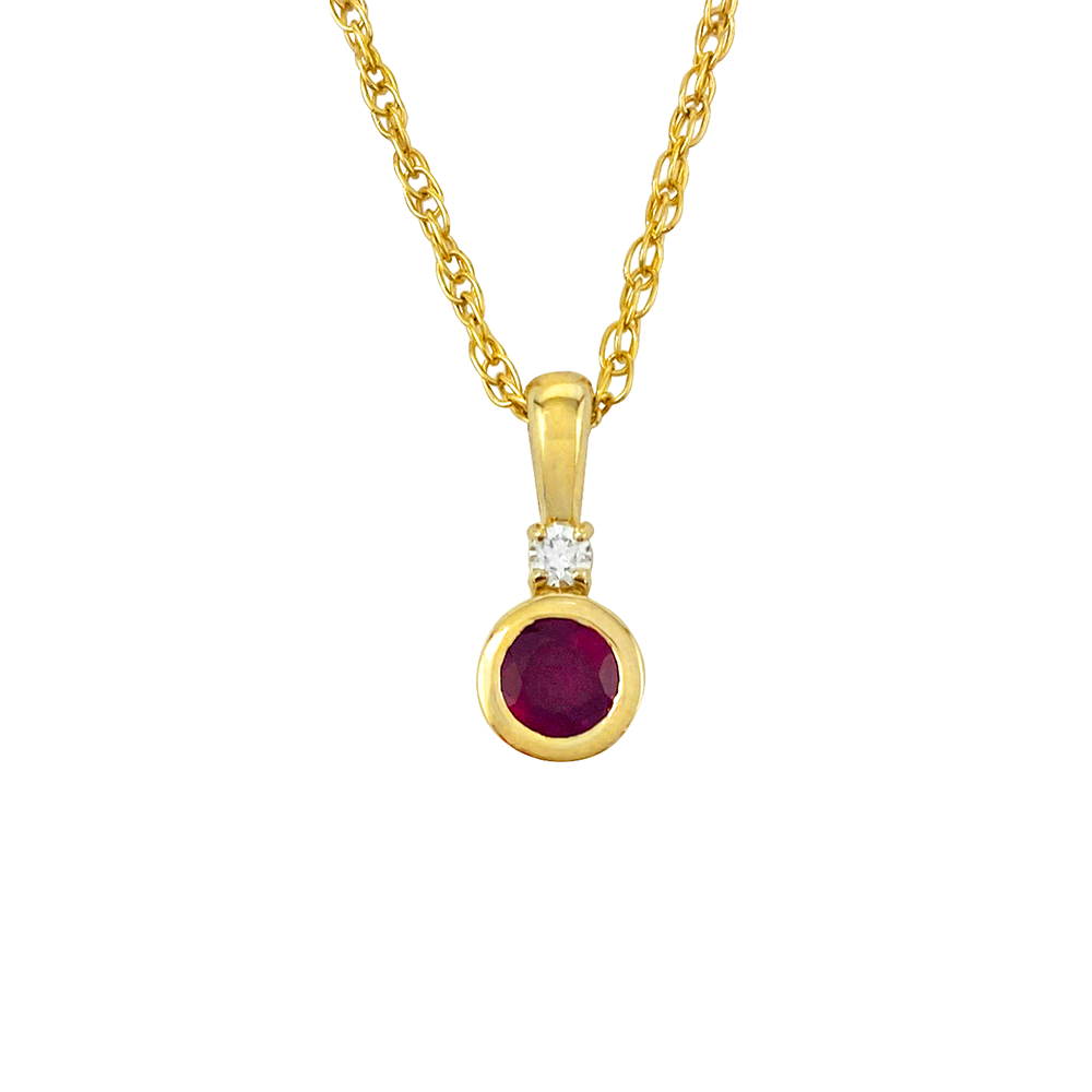 Yellow gold necklace with an oval ruby pendant and a diamond accent, on a white background.