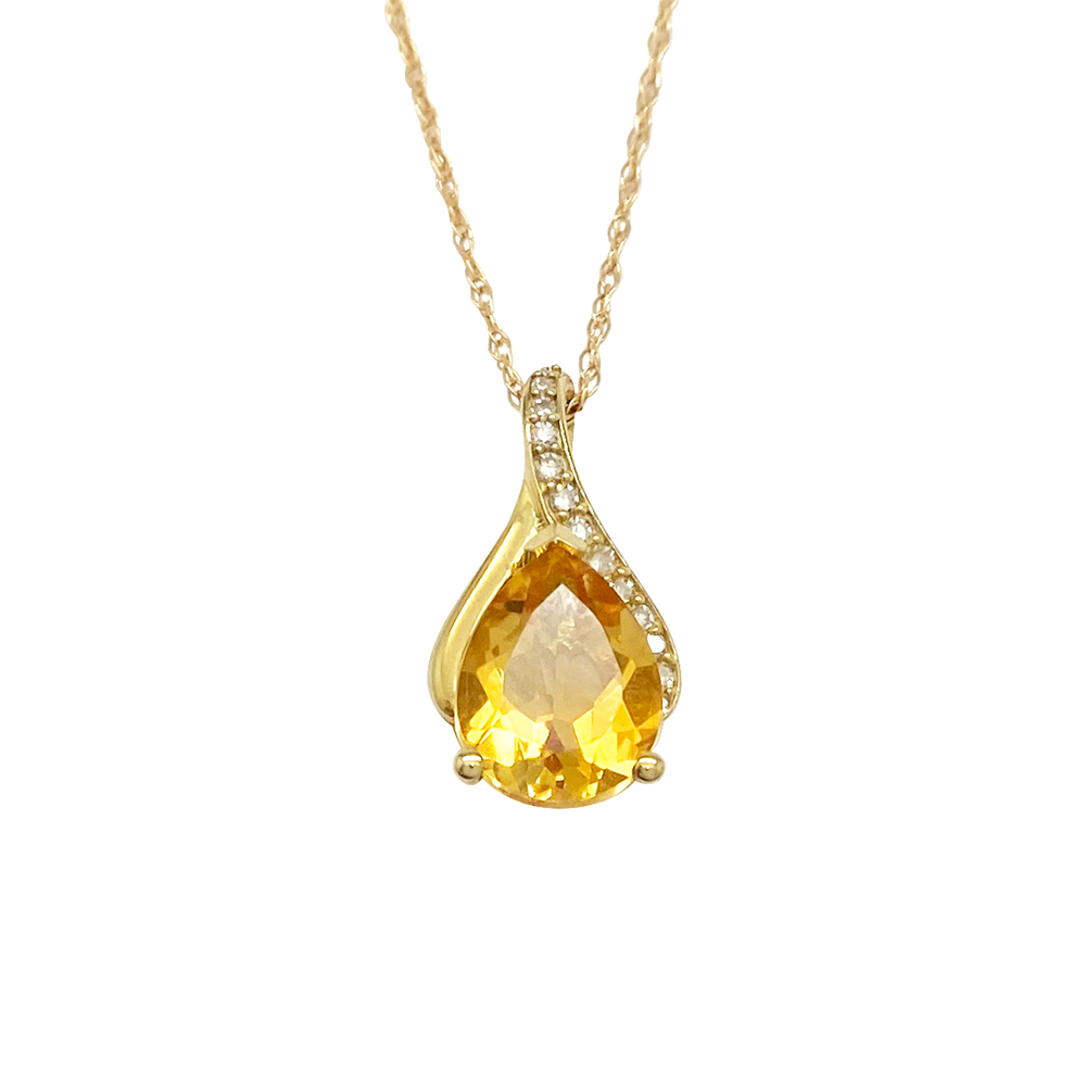 Yellow gold necklace with a pear-shaped citrine pendant and diamond accents, on a white background.